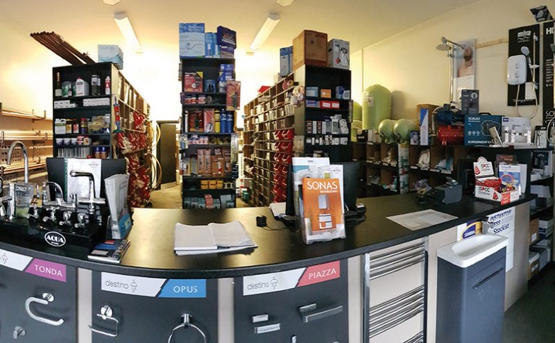 Store interior with shelves stocked with products and a counter area.